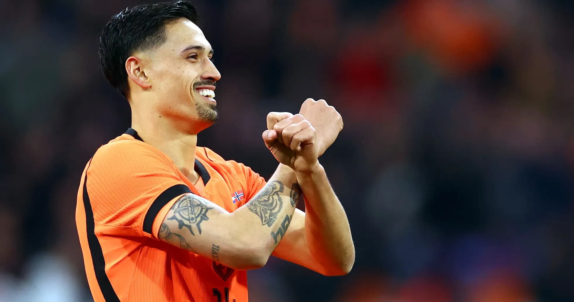 Player celebrating with clenched fists in orange jersey