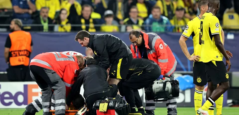 Medical staff attending to a player on the ground