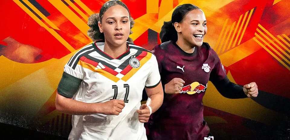 Two female soccer players in team jerseys smiling