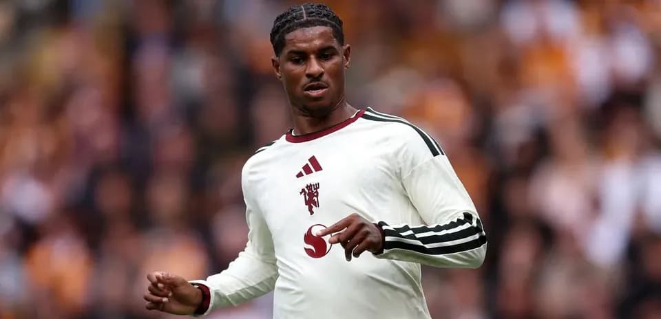 Player in white kit during football match action