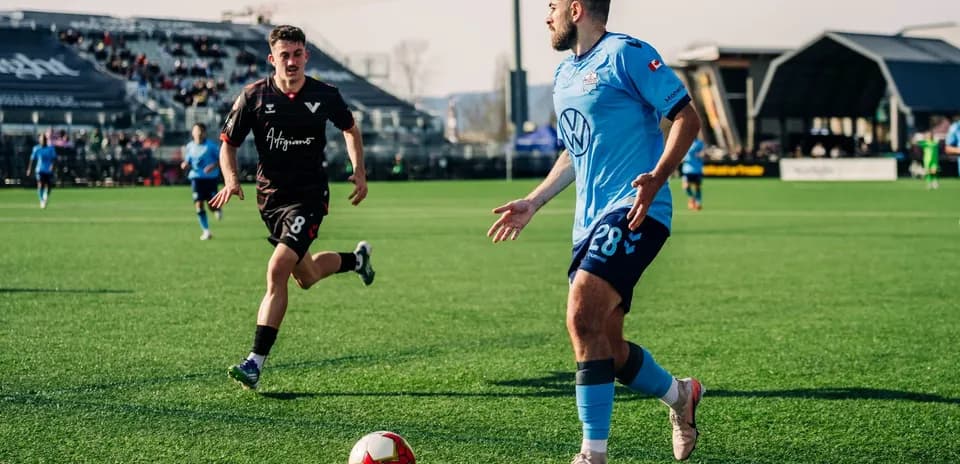 HFX Wanderers player dribbling during match