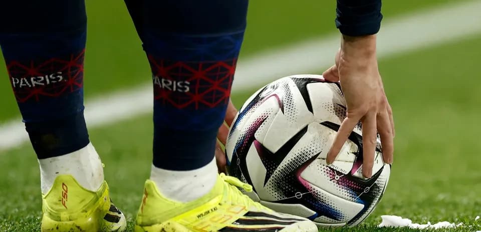 Player preparing to take a free kick with ball