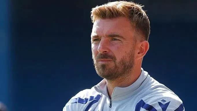 Man with beard observing during training session