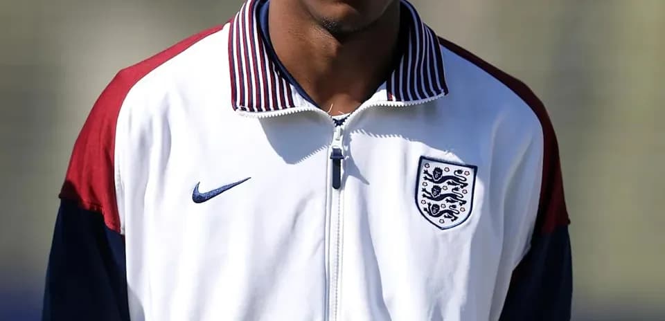 Player in England training jacket on field