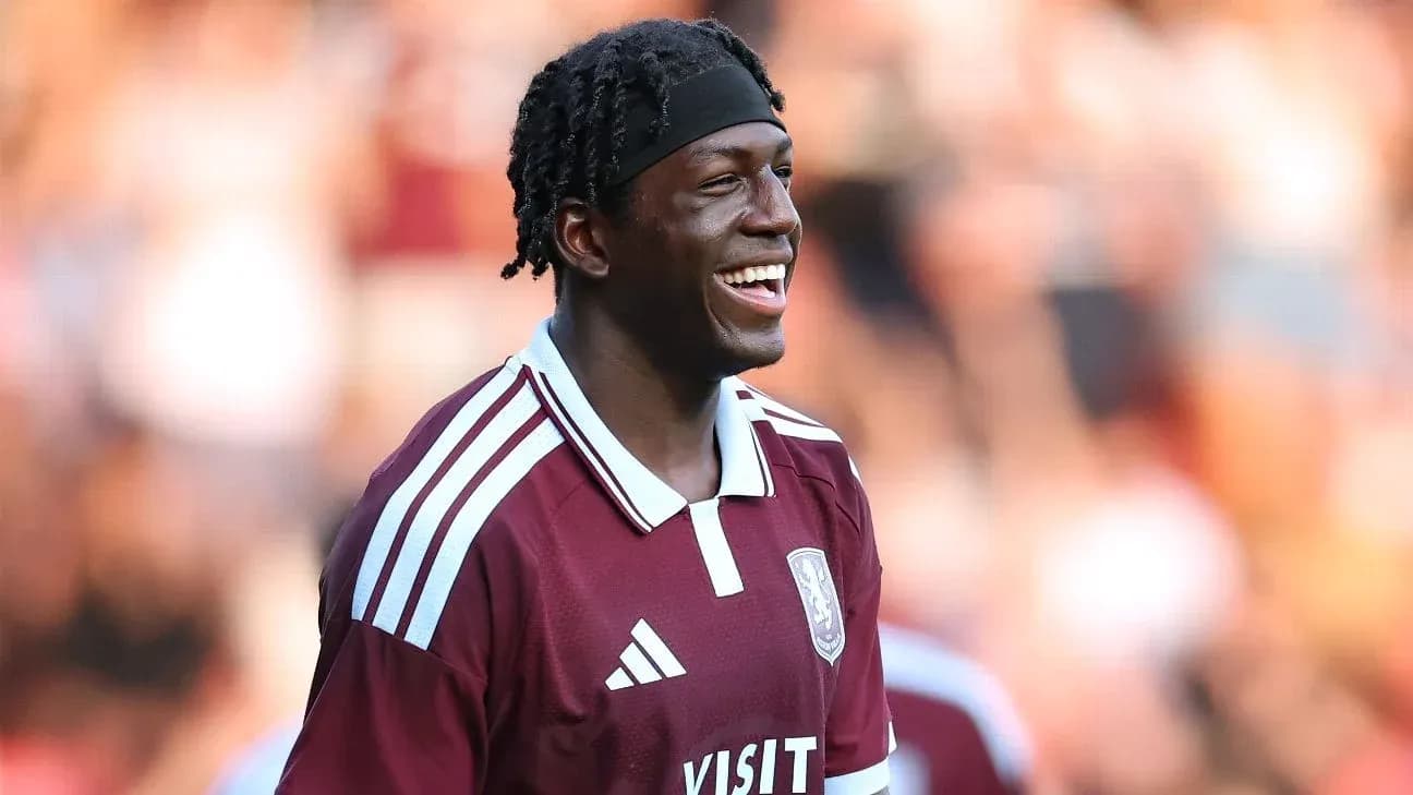Player smiling while wearing maroon team jersey