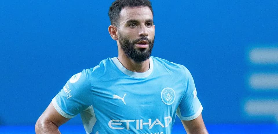 Player in Manchester City jersey on the pitch