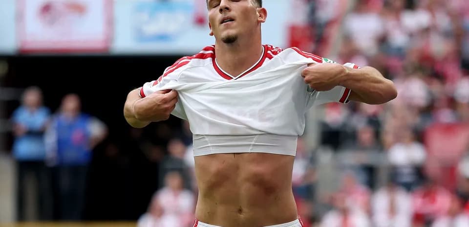 Player lifting shirt during football match celebration