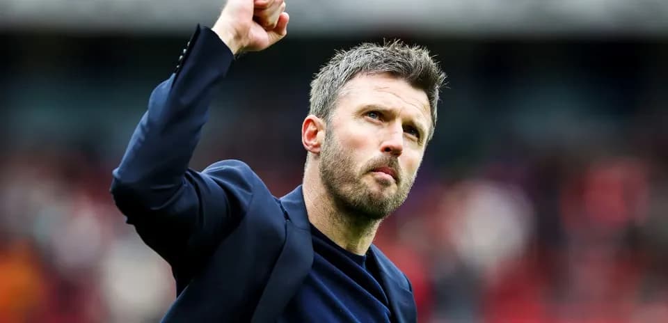 Manager celebrating with raised fist on pitch