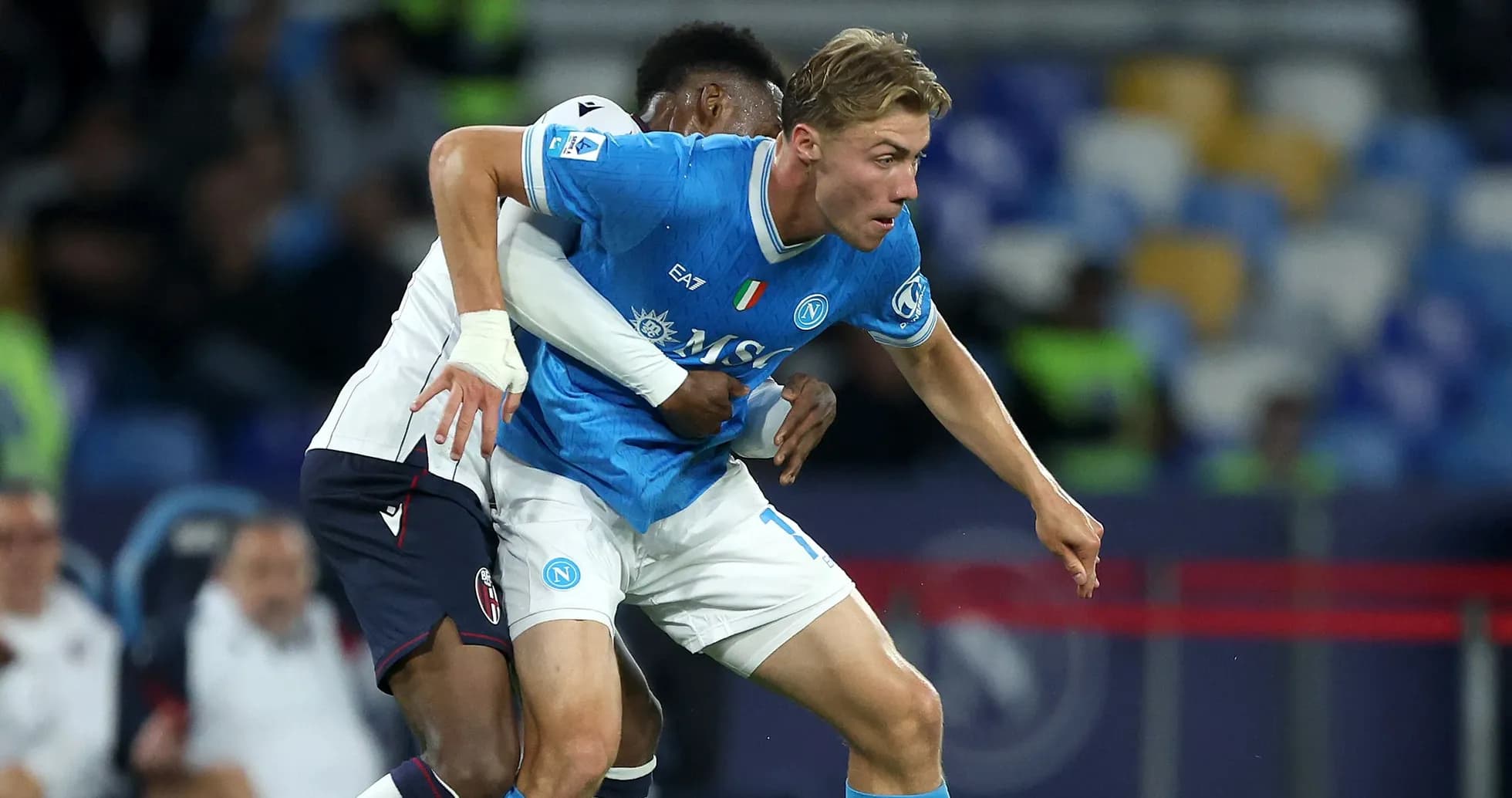 Napoli player being challenged by opponent during match