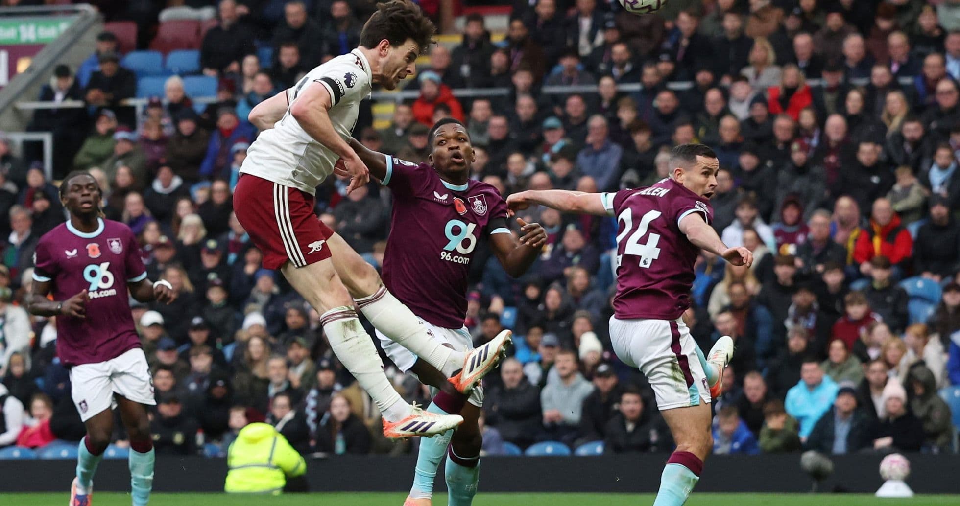 Arsenal player jumping for a header against Burnley