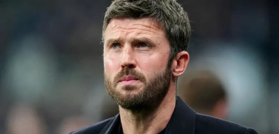 Man in suit looking intently during match