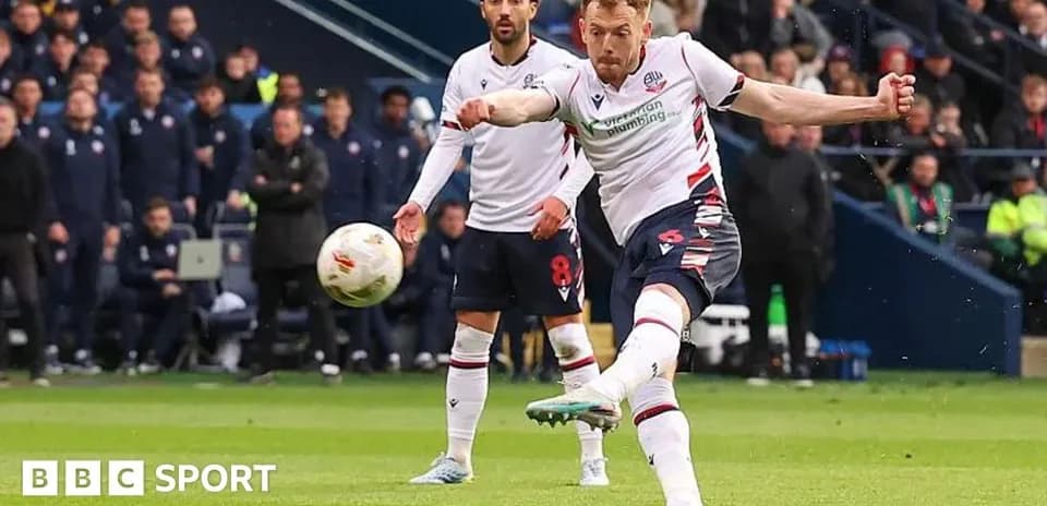 Player striking the ball during a football match