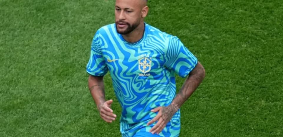 Player running on field in Brazil kit
