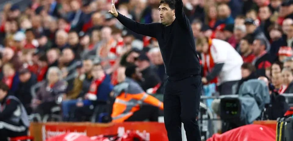 Coach gesturing on the sidelines during match