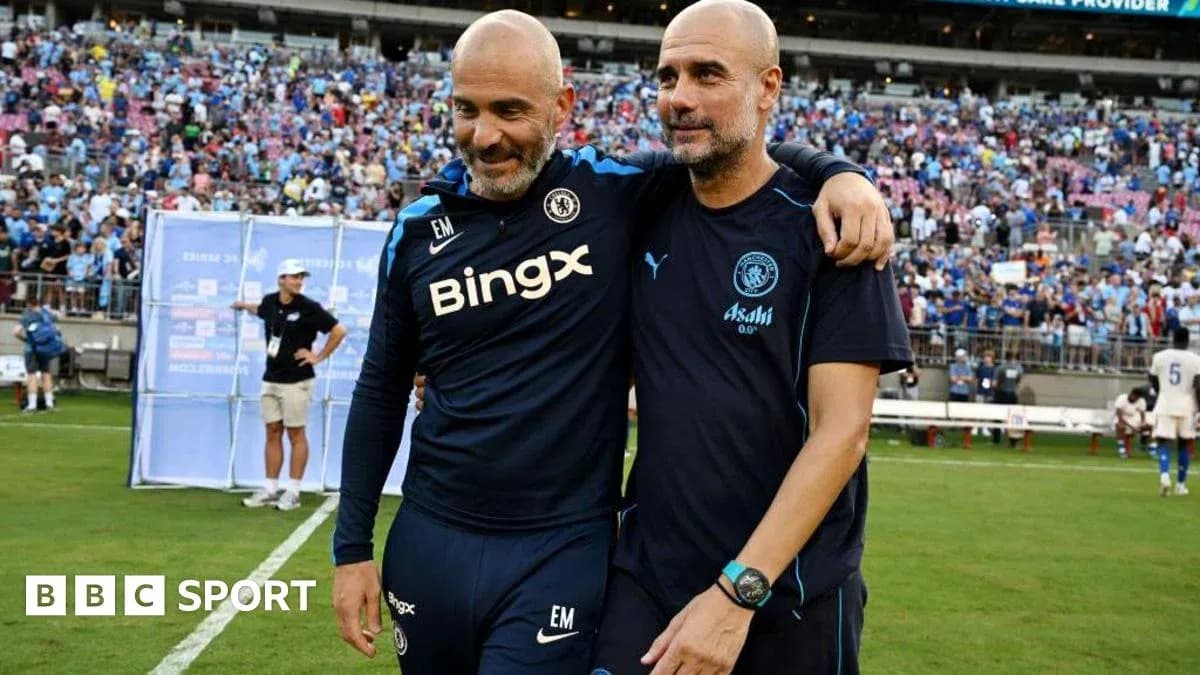 Two coaches embracing on the field after match