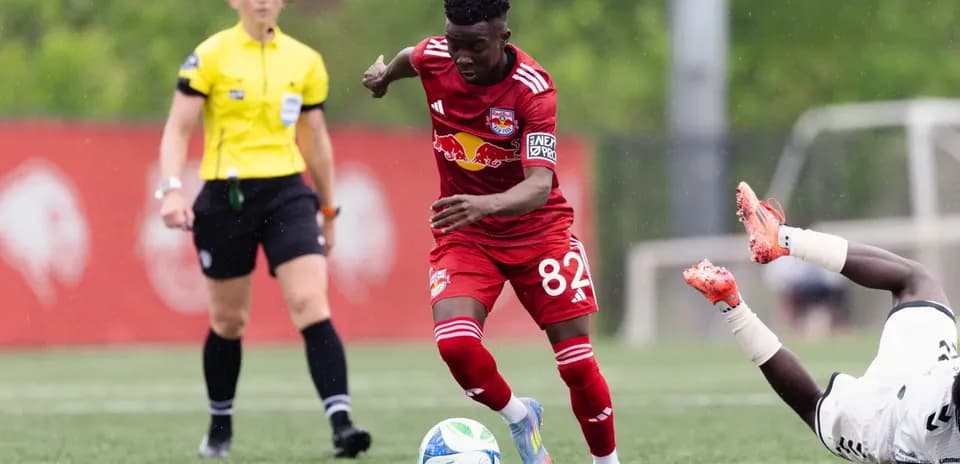 Player in red jersey dribbling the ball