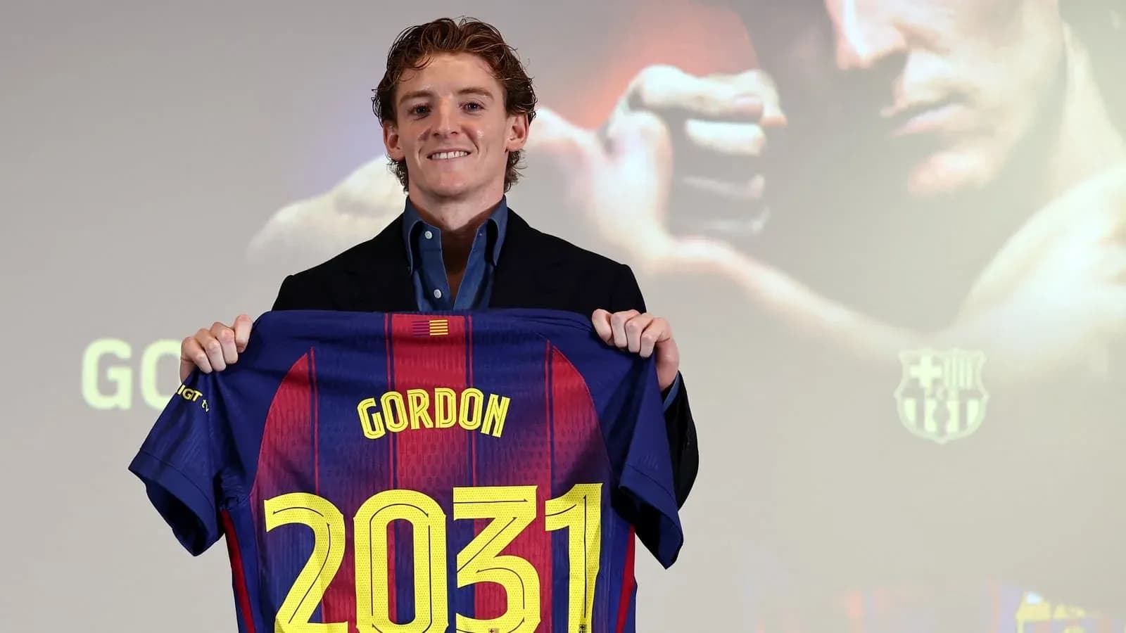 Player holding Barcelona jersey with name and number
