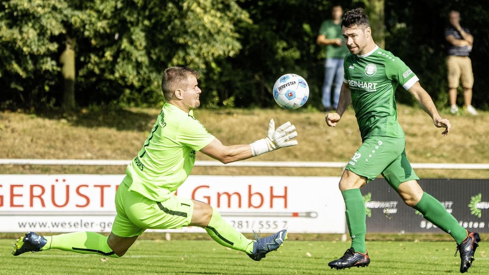 Goalkeeper attempting to catch a ball during match