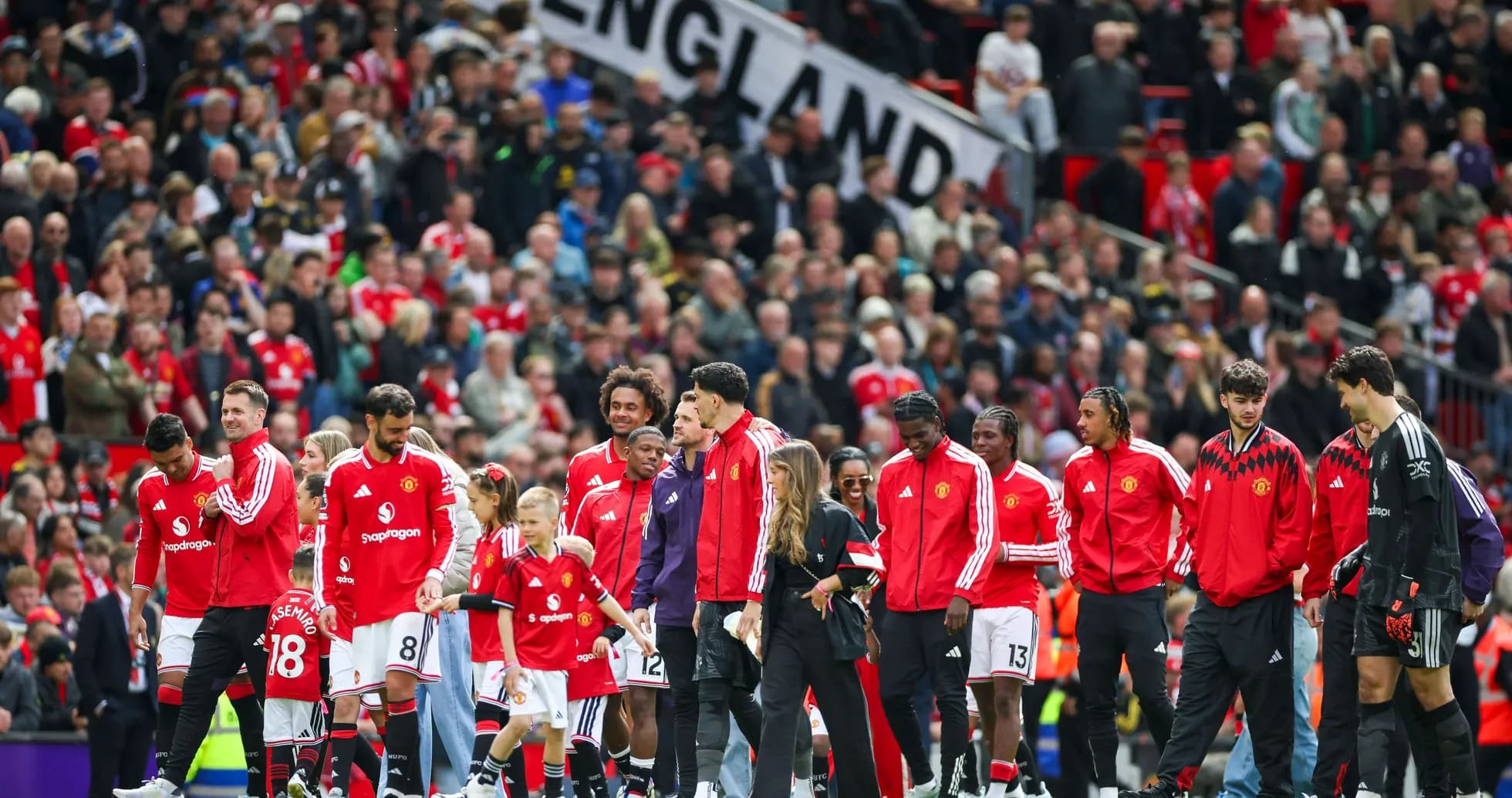 Manchester United players entering the pitch with fans