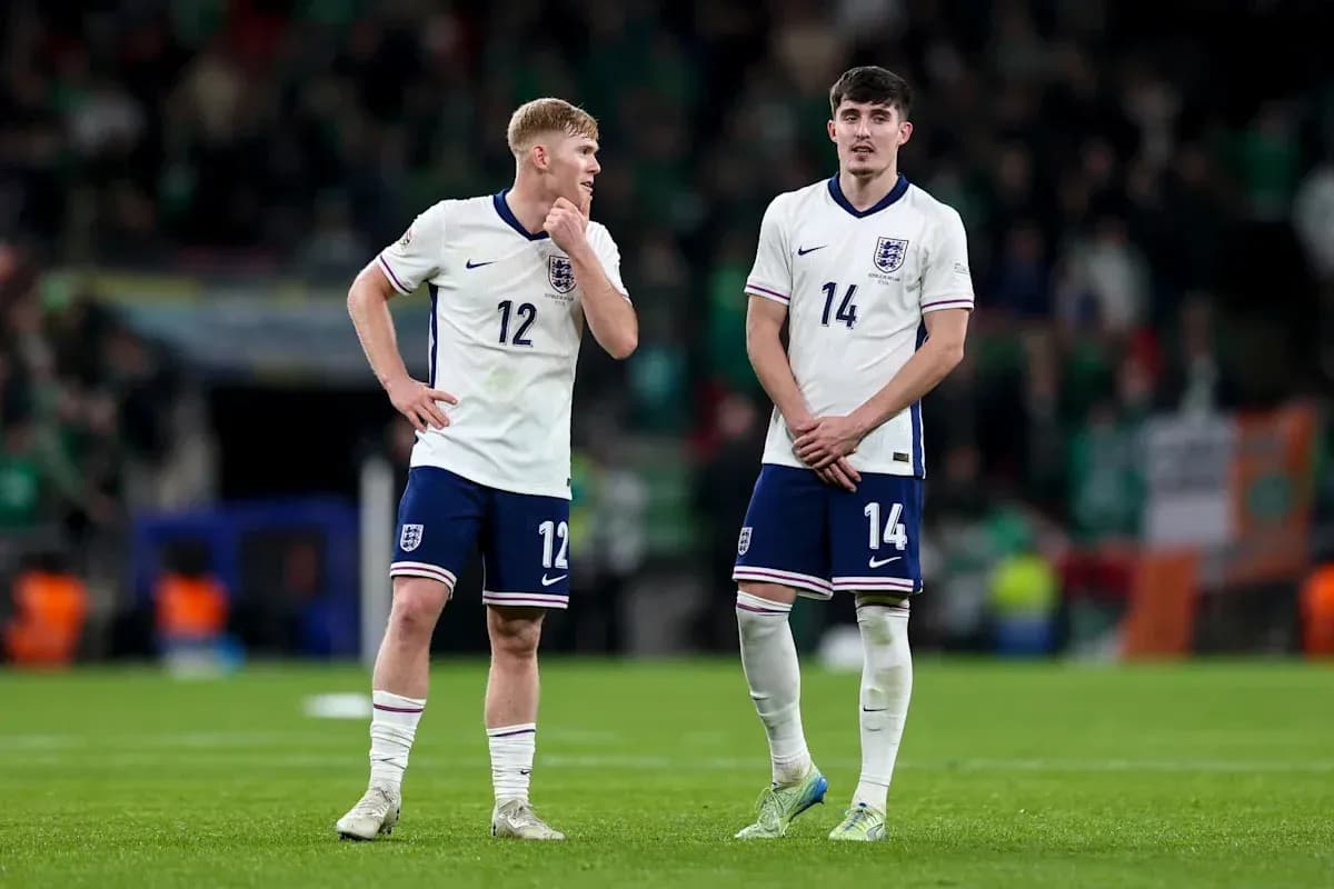 Two England players discussing on the pitch
