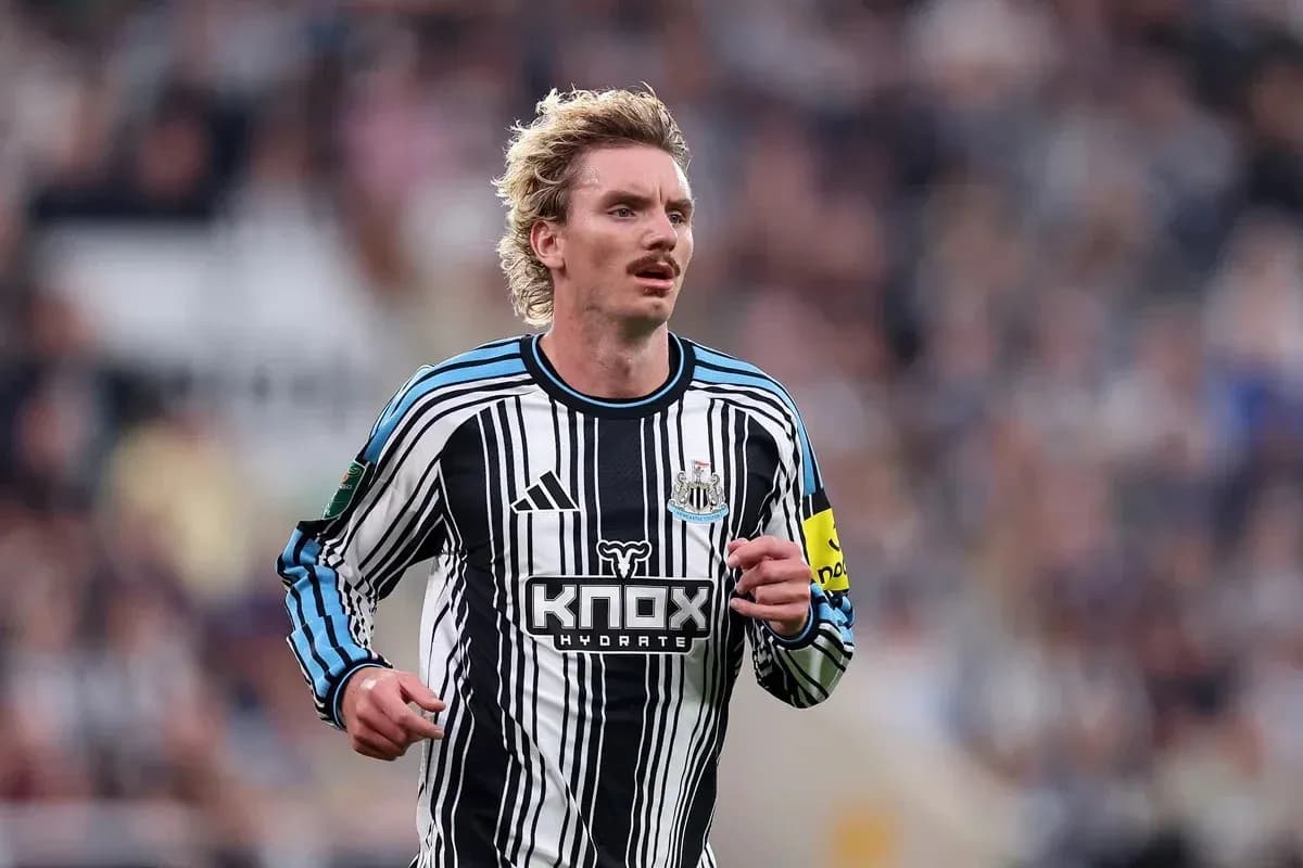 Player running in Newcastle United home kit