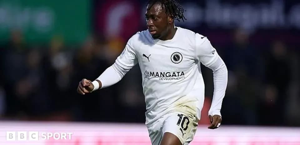 Player celebrating a goal in white jersey