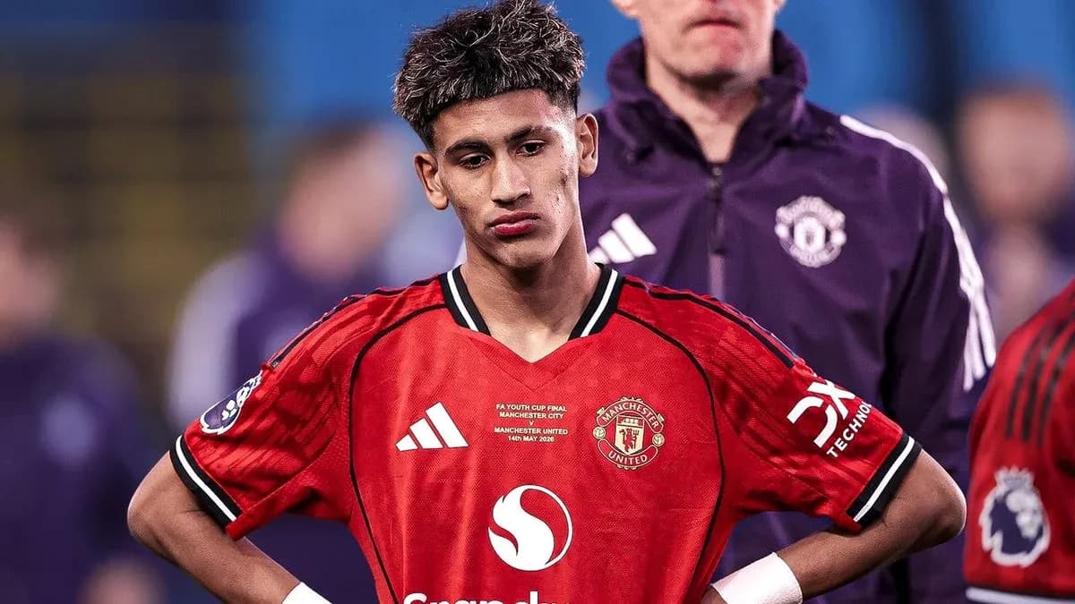 Young player wearing Manchester United jersey looking down Young player wearing Manchester United jersey looking down