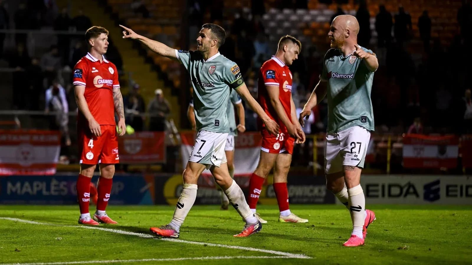 Players celebrating a goal on the pitch