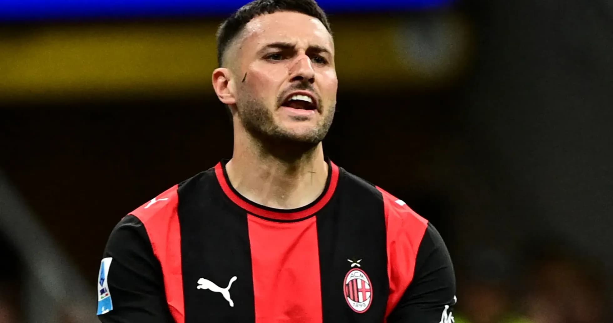 Player reacting during match wearing AC Milan jersey