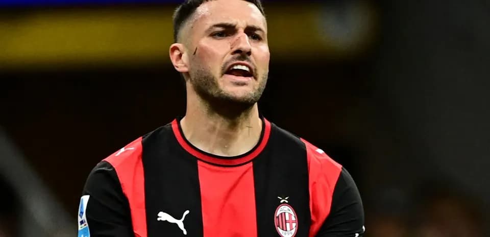 Player reacting during match wearing AC Milan jersey