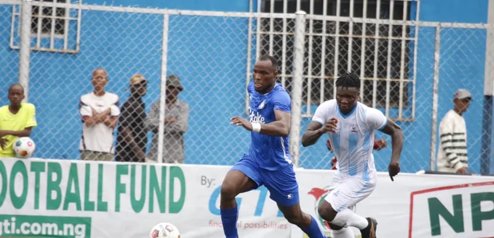 Two players competing for the ball in NPFL match