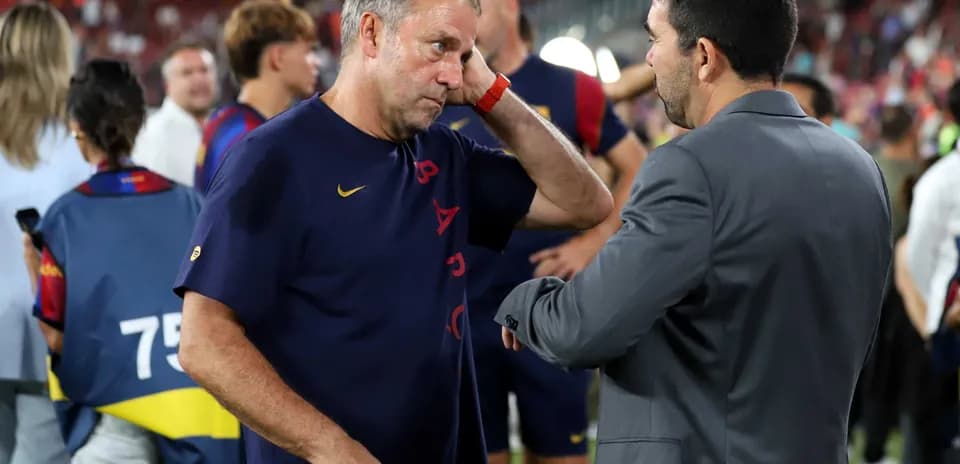 Coaches discussing on the field after the match