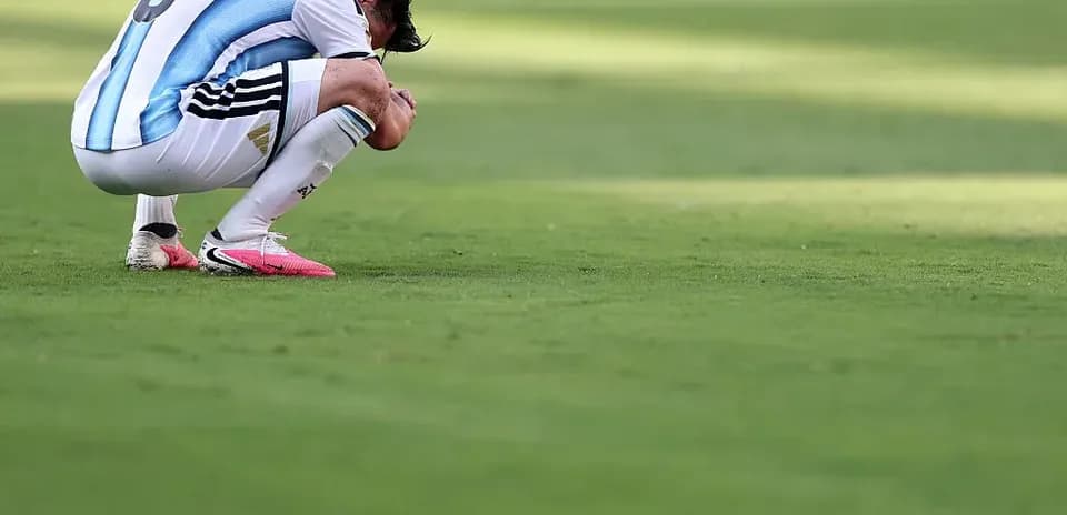Player kneeling on pitch after match