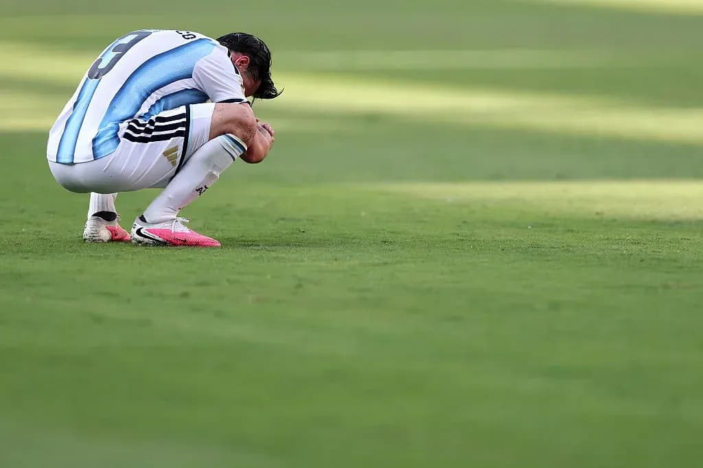 Player kneeling on pitch after match