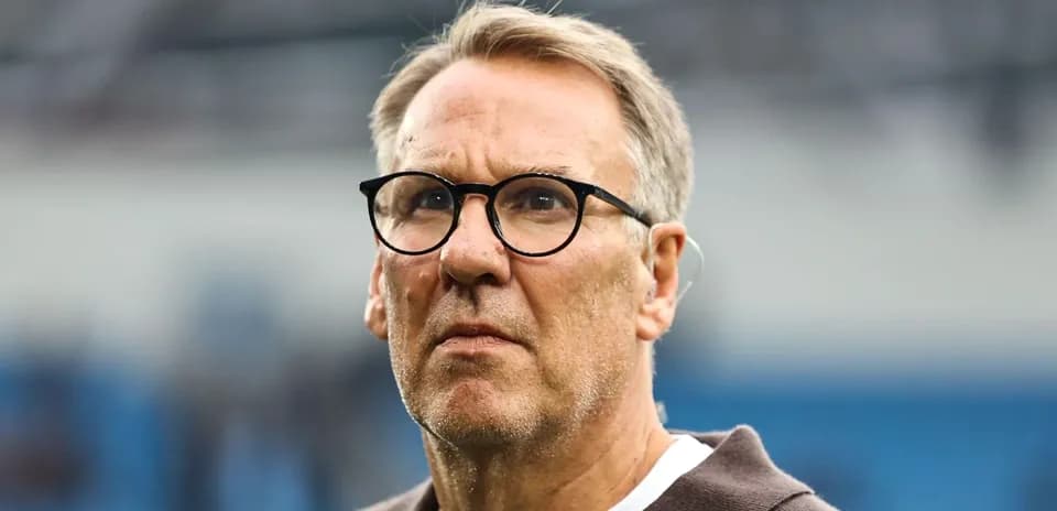 Man with glasses looking intently on the field