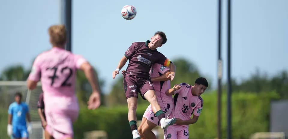 Player jumping for header during match