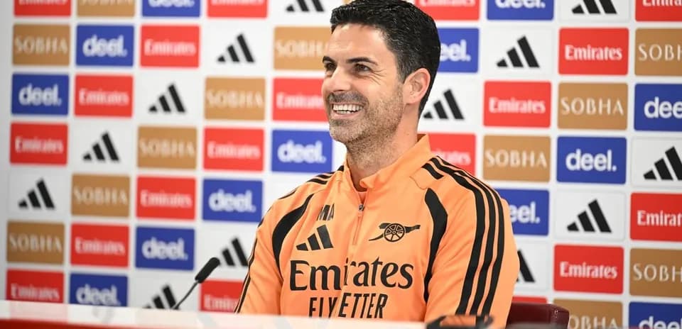 Manager speaking at press conference with branding backdrop