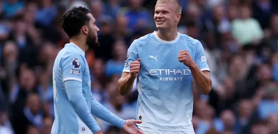 Manchester City players celebrating on the pitch