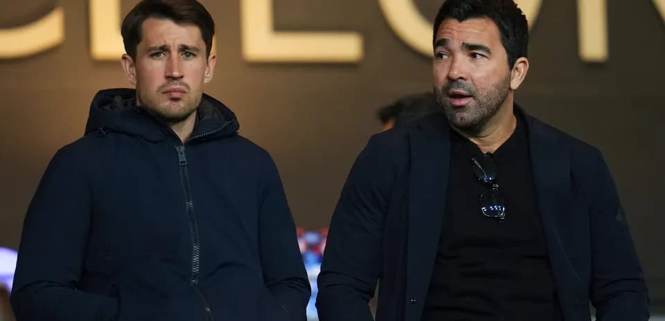 Two men sitting in a sports venue