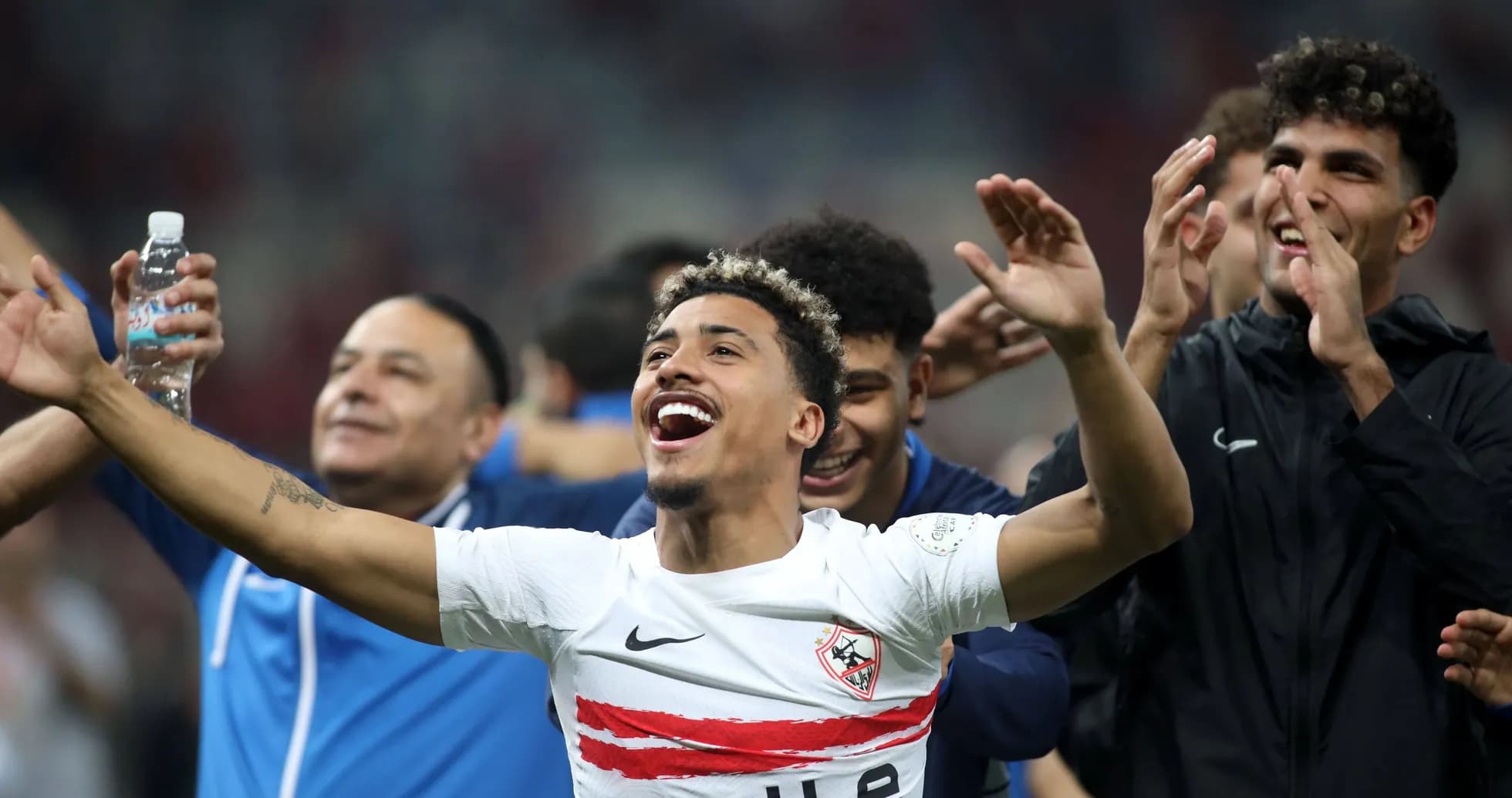 Players celebrating with arms raised after match