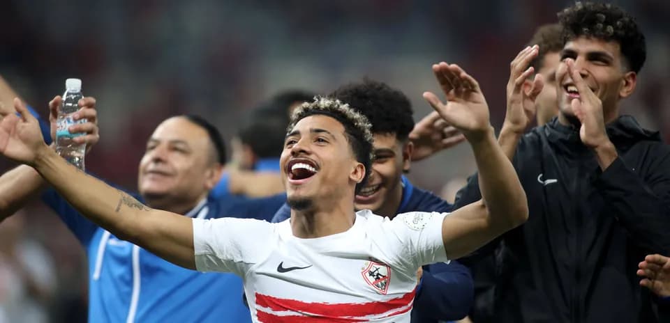 Players celebrating with arms raised after match