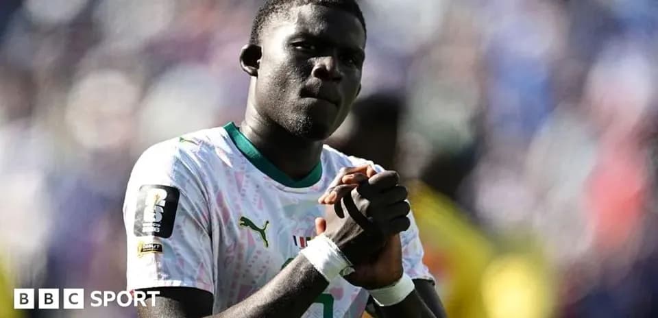 Player clasping hands during match celebration
