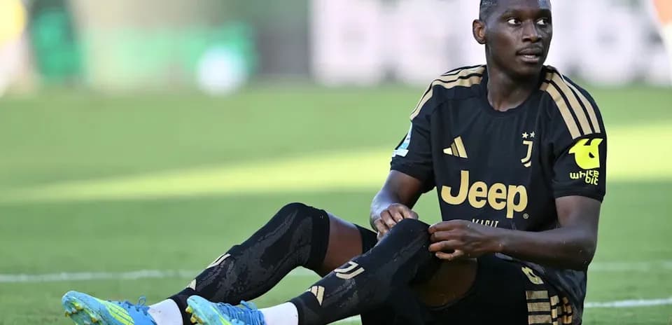 Player sitting on pitch during match recovery