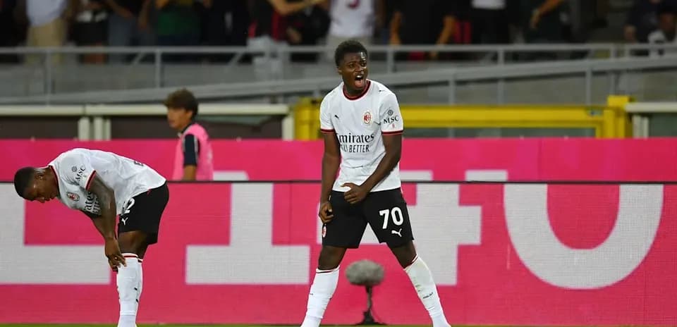 Player celebrating a goal with teammates in stadium