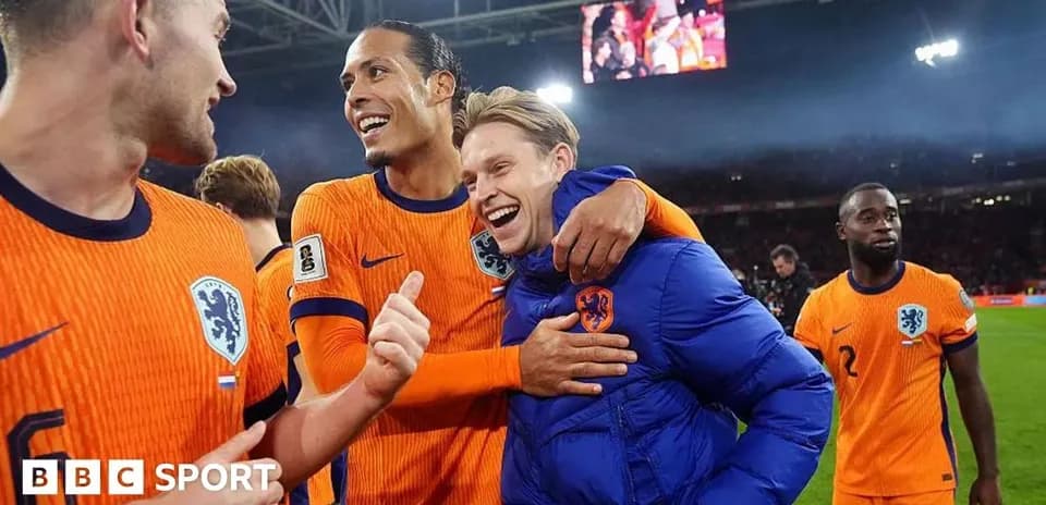 Players celebrating after a match in orange jerseys