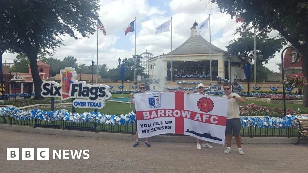 Fans holding Barrow AFC flag at Six Flags Texas
