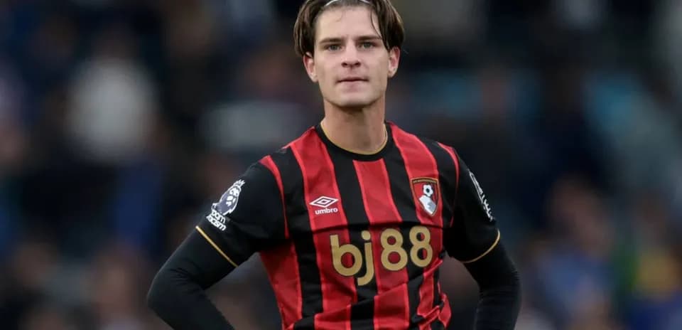 Bournemouth player in black and red kit on field