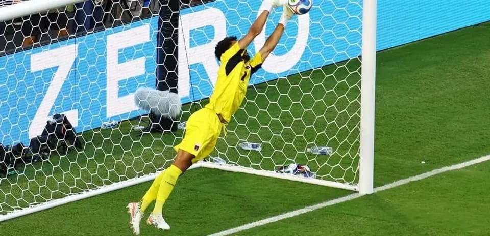Goalkeeper diving to save a shot on goal