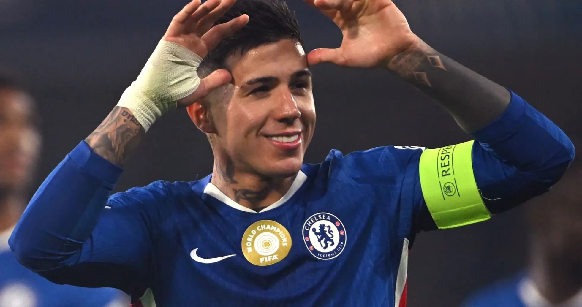 Chelsea player celebrating with arms raised