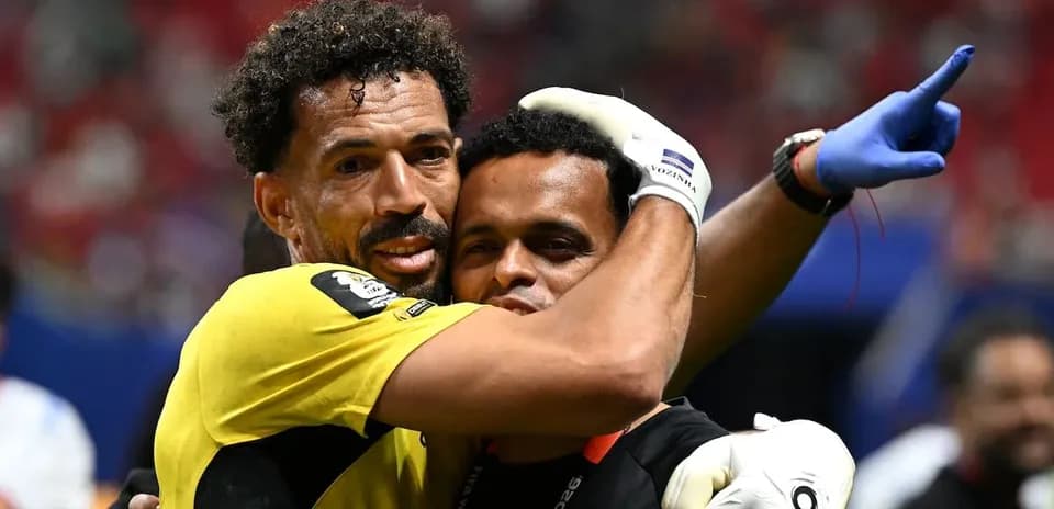 Goalkeeper embracing teammate after match victory